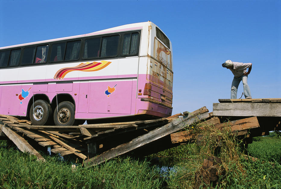 A tourist bus packed with people splinters a wooden bridge on the Transpantaneira Highway, Pantanal.... [Photo of the day - 5 DECEMBER 2011]