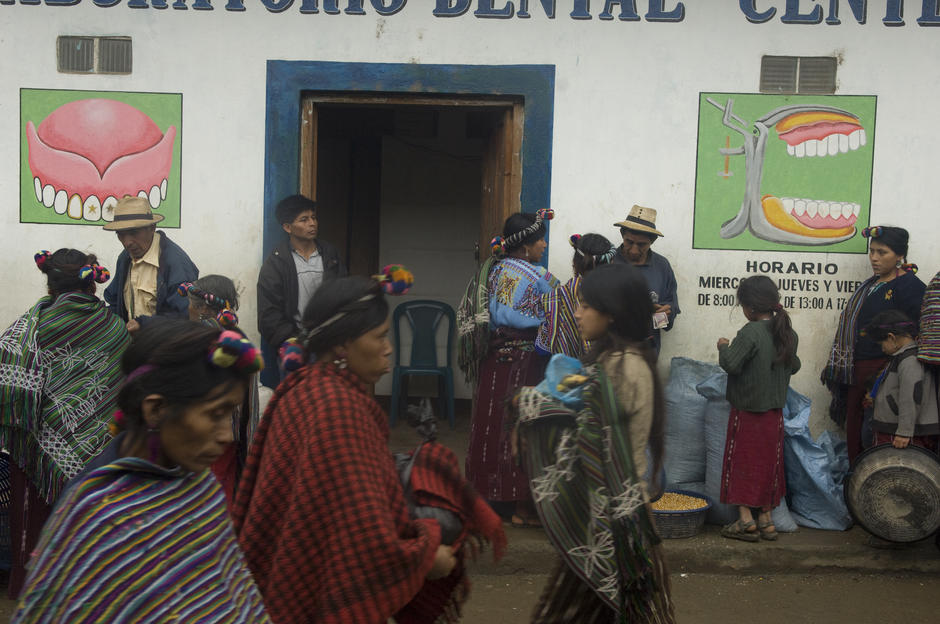 Local people milling on a street outside a dental clinic. [Photo of the day - FEBRUARY 19, 2011]
